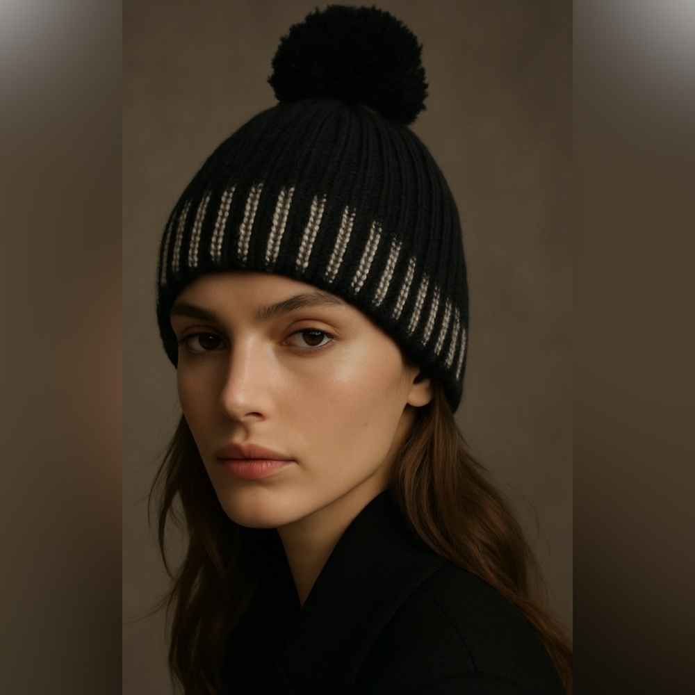 Nixon black knit pom-pom beanie with a gold foil-like finish on the brim